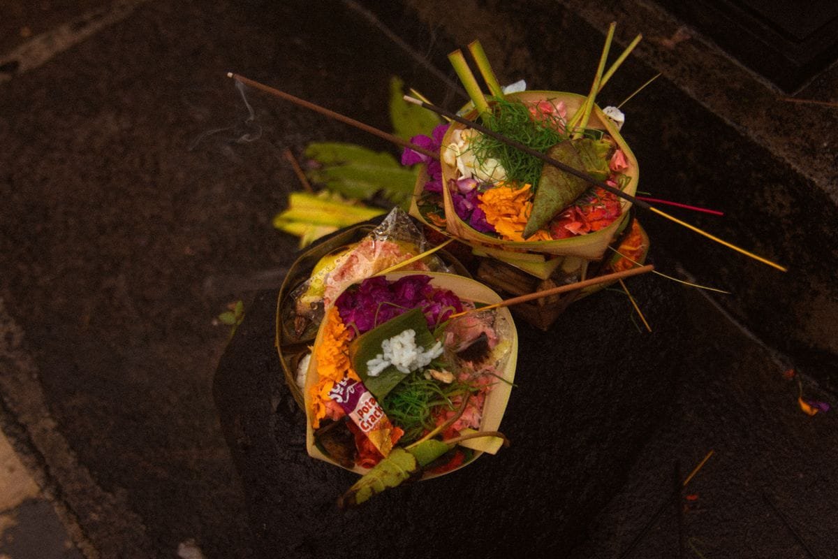 Balinese canang sari offering with flowers and incense